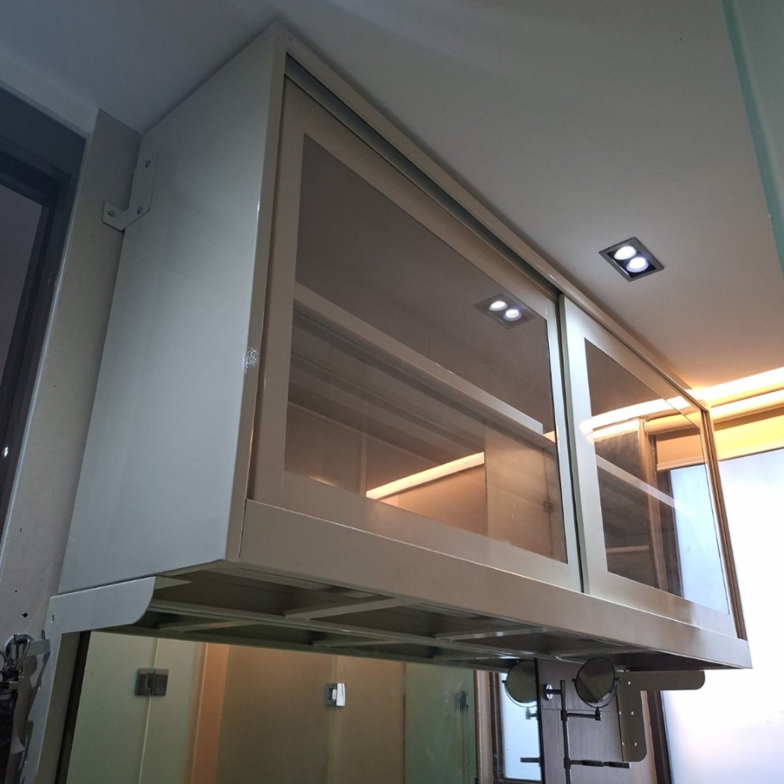 Custom overhead steel cabinet with sliding glass doors